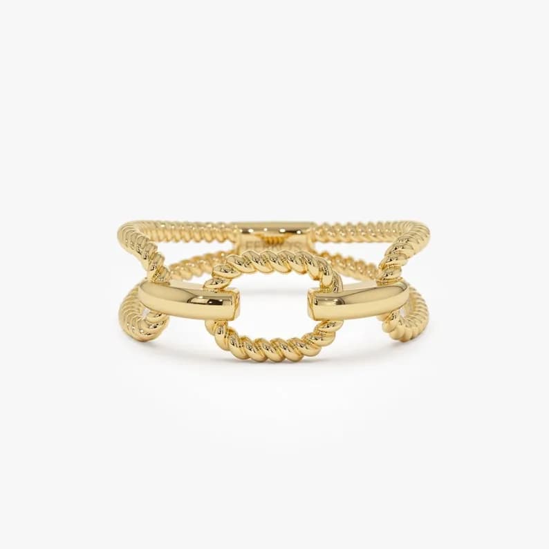 Gold ring with a twisted rope design and a large oval-shaped link.