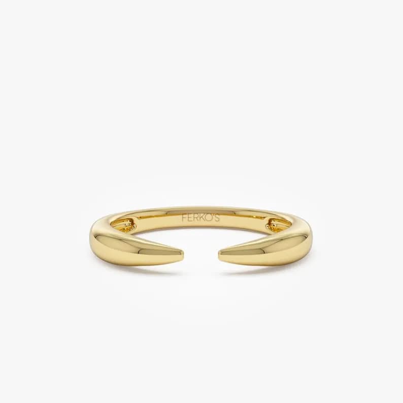 Gold ring with two pointed ends, marked with 'FERKO'S' on the inside.