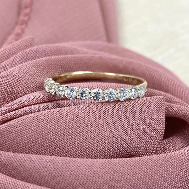 Delicate gold band with a row of sparkling round diamonds.